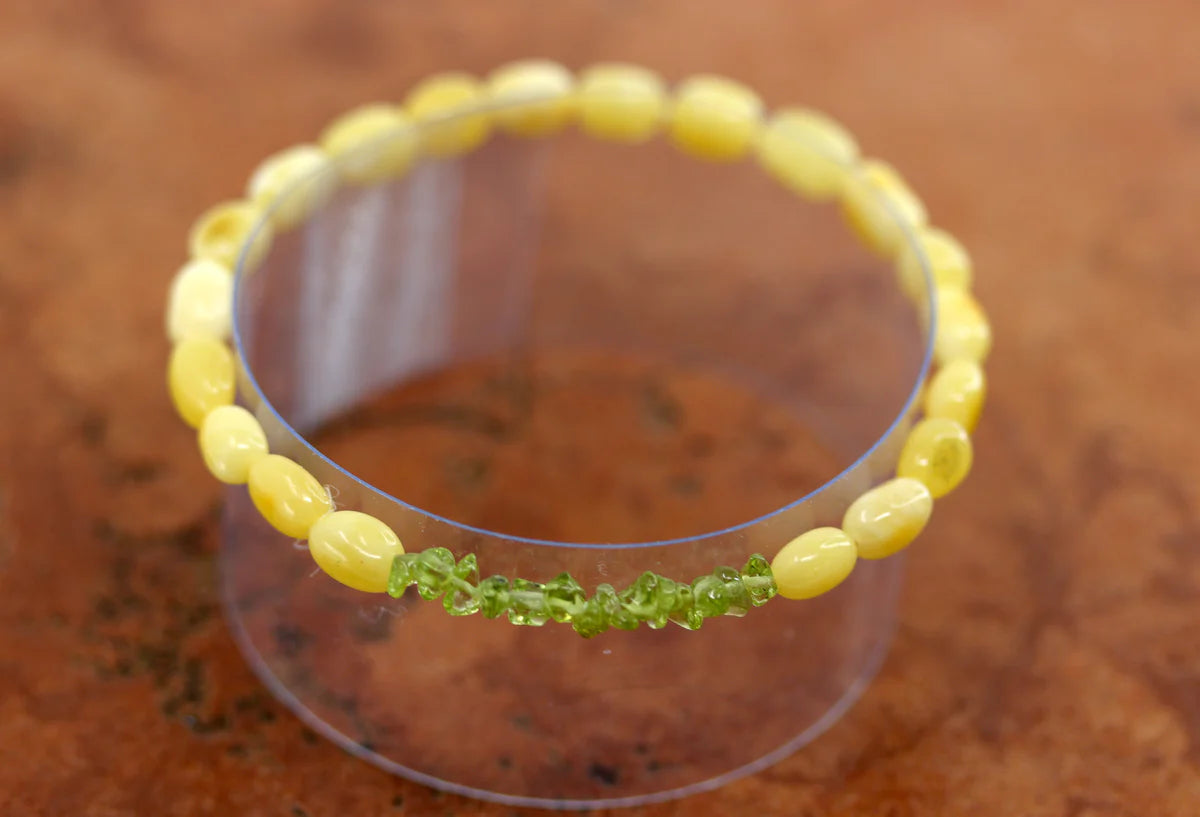 Stretch bracelet with yellow beads made from amber and peridot