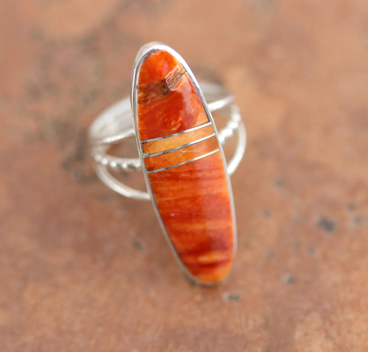Beautiful Navajo Native American ring. It is made from sterling silver and spiny oyster. The ring size 7 1/2 and it is 1 3/8" in length.

