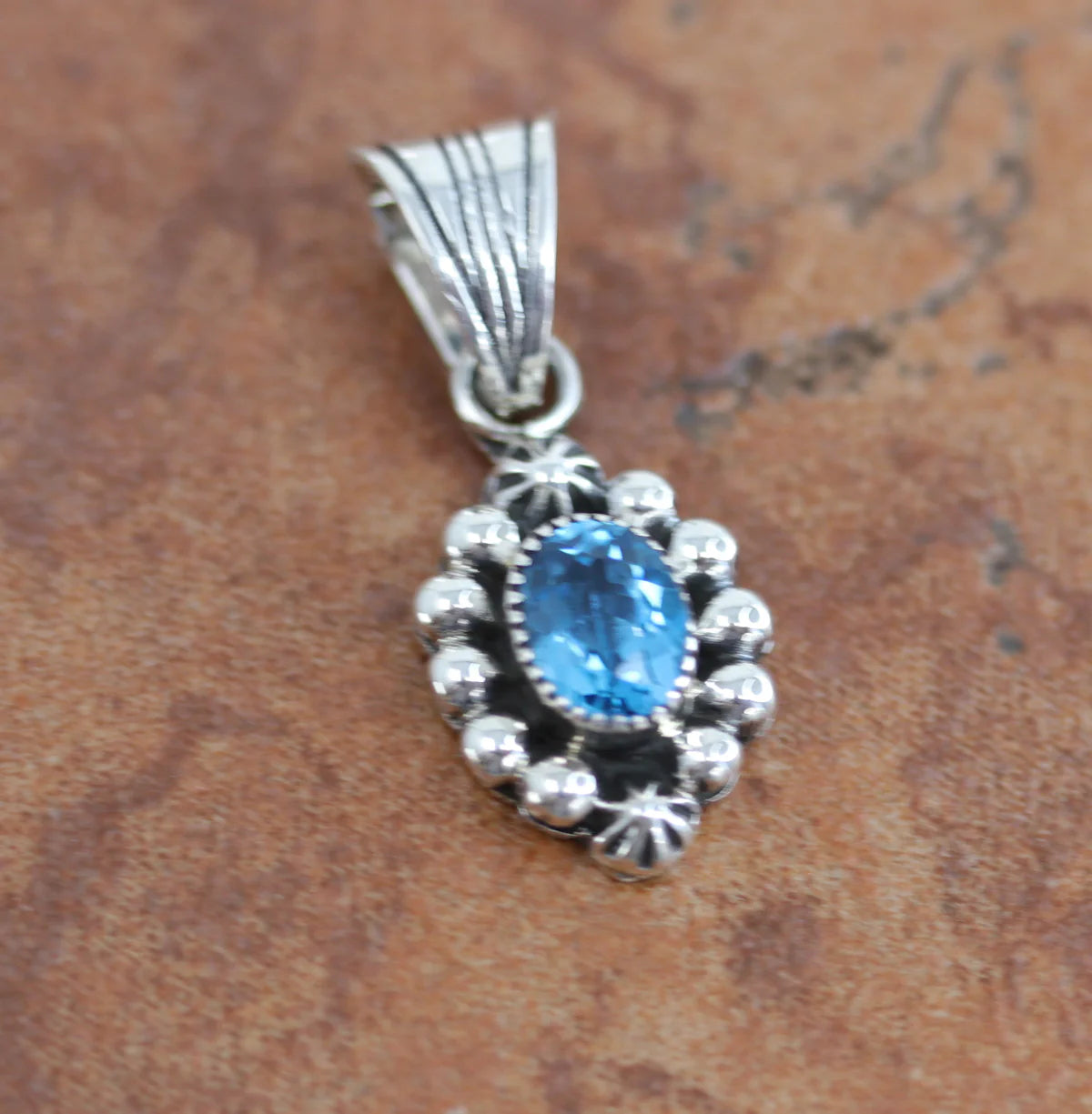 A Beautiful Navajo Native American Pendant by Mike Smith. It is made from sterling silver and aquamarine. The pendant is about 1 1/4" in length and about 5/8" in width. It is stamped Sterling and by the artist.

