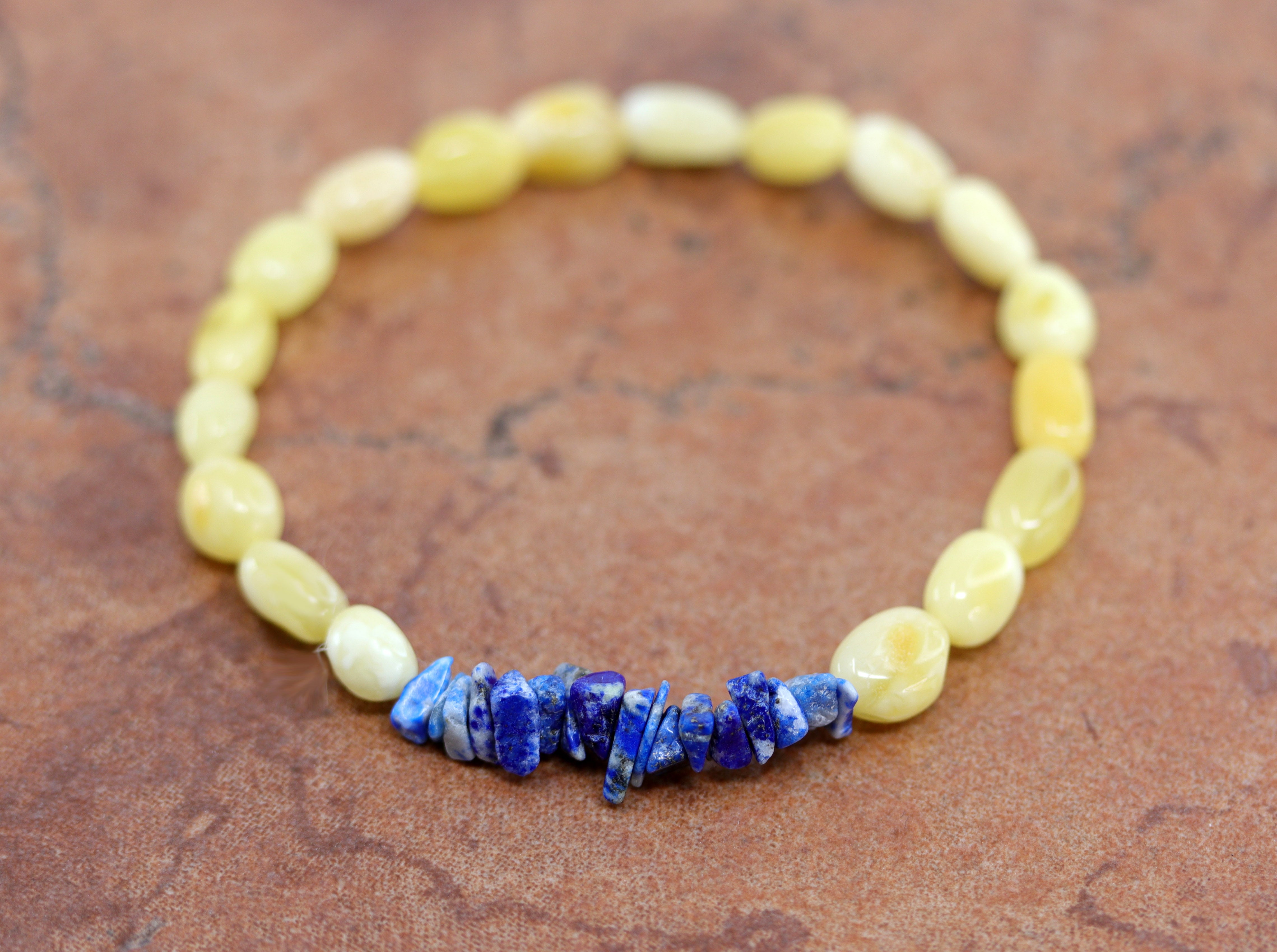 Stretch bracelet with yellow beads made from Baltic Amber and blue beads made from denim lapis