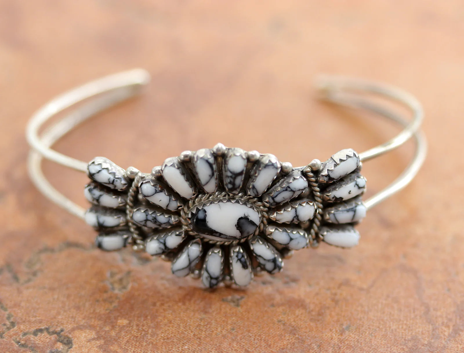 Silver cuff bracelet with a cluster of white howlite gemstones