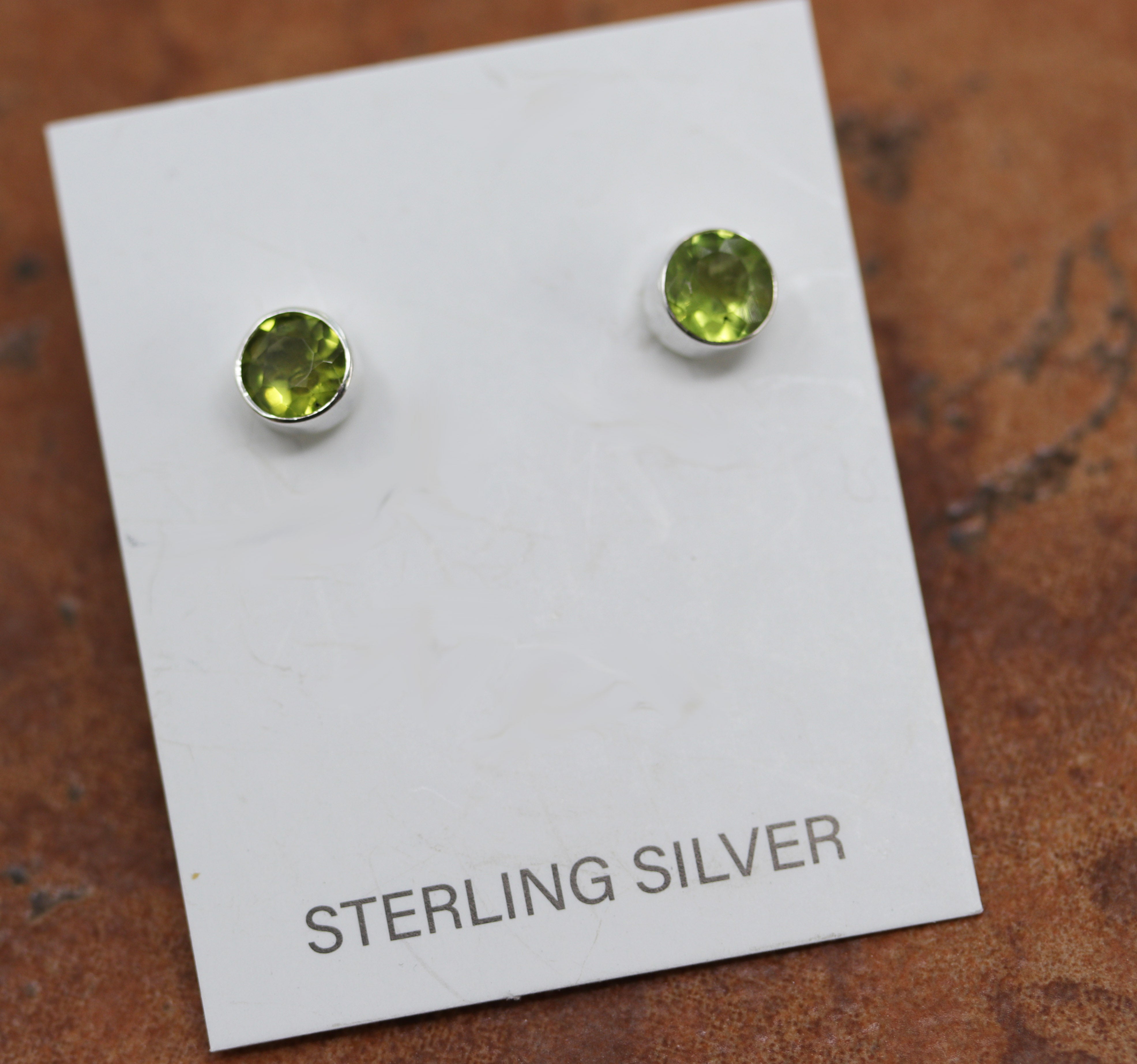 Silver circular stud earrings with green citrine stones